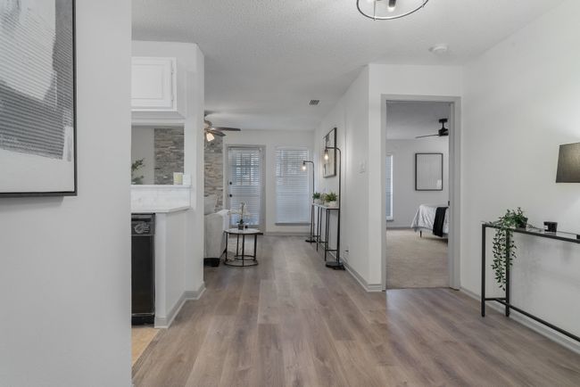 Hall featuring baseboards, wood finished floors, and a textured ceiling | Image 7