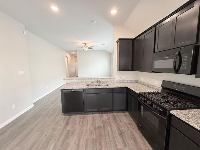 14501 SUGAR PINES DR - Eating area in Kitchen with all black appliances, refrigerator included | Image 22