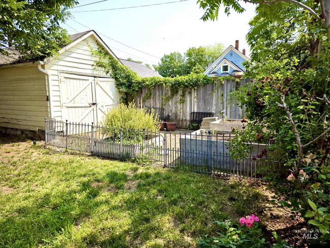 View of yard with a storage unit | Image 21