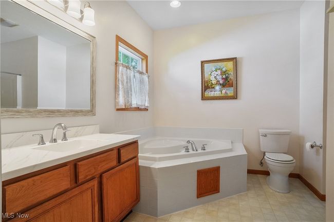 Full bath featuring toilet, vanity, a garden tub, and visible vents | Image 32