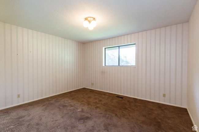 Unfurnished room with carpet and a textured ceiling | Image 11