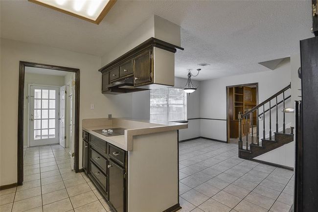 Spacious kitchen opens to a breakfast area and the staircase. | Image 7