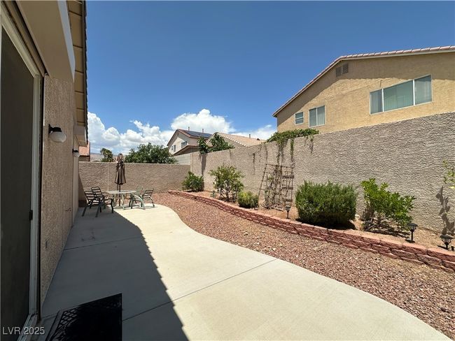 Fenced backyard with a patio | Image 27