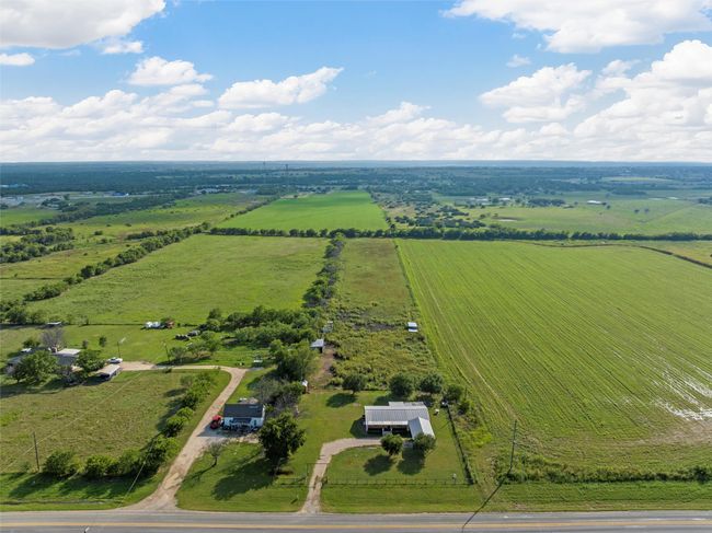 Aerial view of sparsely populated area featuring farmland | Image 28
