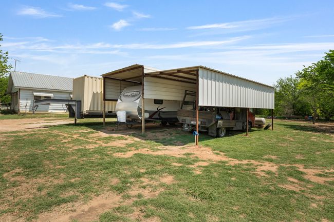 View of outdoor structure with driveway and a detached carport | Image 29