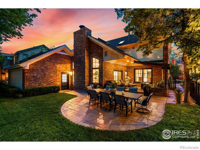 Stone Outdoor Patio. New Windows and French Doors with Black Trim throughout back of Home. Huge Lot with Potential to PopTop and Expand Home. | Image 35