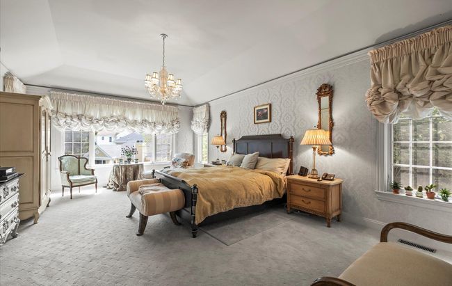 Carpeted bedroom featuring a chandelier | Image 16