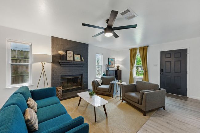 Durable vinyl wood plank flooring throughout adds both style and functionality to this inviting living space. | Image 4