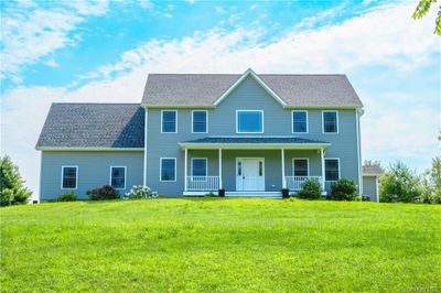 View of front facade featuring a porch and a front lawn | Image 2