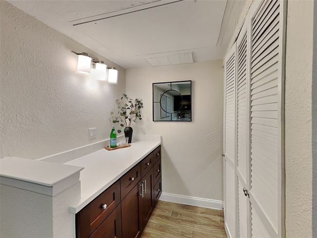 Bathroom with baseboards, vanity, and wood finished floors | Image 12