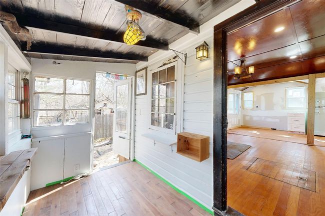 Unfurnished sunroom featuring a healthy amount of sunlight and beam ceiling | Image 5
