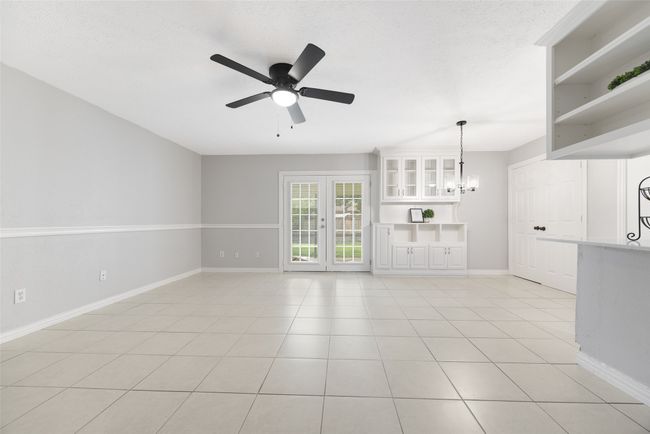 Living room featuring ceiling fan and new fixtures and doors | Image 4