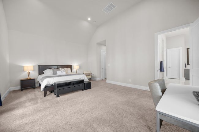 Carpeted bedroom featuring baseboards and high vaulted ceiling | Image 17