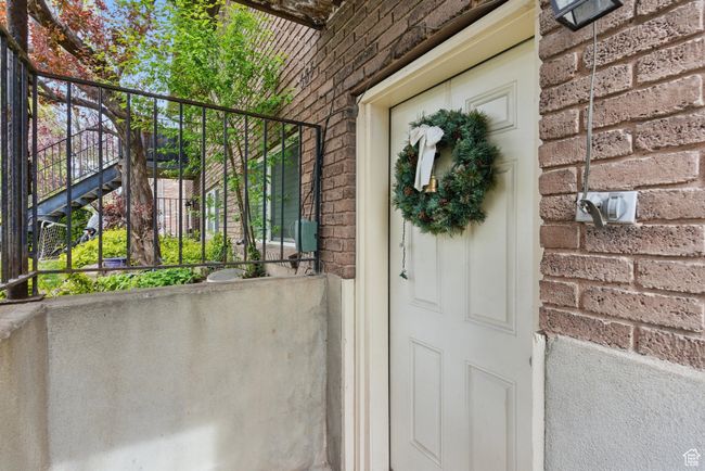 View of exterior entry featuring brick siding | Image 4