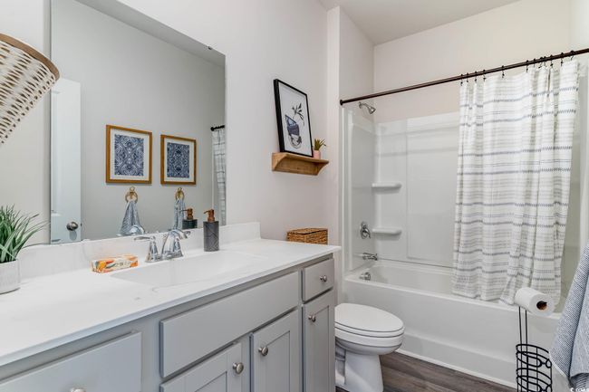 Full bathroom featuring vanity, shower / tub combo, and wood finished floors | Image 18