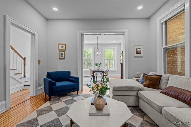 Living room featuring baseboards, wood finished floors, recessed lighting, and stairs | Image 8