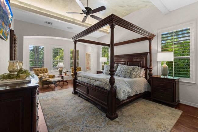 The master bedroom is downstairs and tucked away quietly from all entertainment areas...The barrel ceiling w/uplighting creates a relaxing ambiance. Relax and kick back in the seating area to curl up to read a book... | Image 30