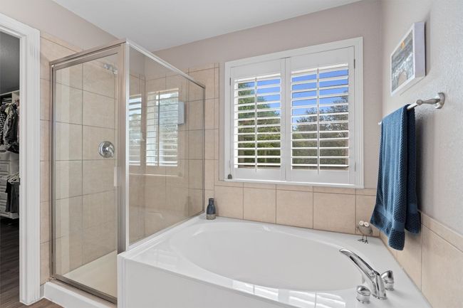 Full bathroom with a garden tub, a shower stall, and a spacious closet | Image 17