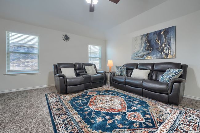 Living area featuring carpet, ceiling fan, and baseboards | Image 24