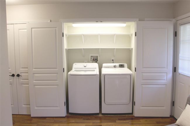 Laundry area with laundry area, independent washer and dryer, and dark wood-type flooring | Image 18