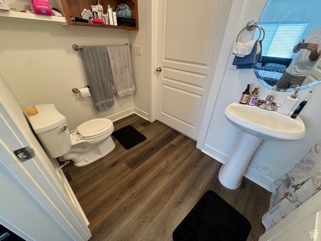 Bathroom with toilet, baseboards, and wood finished floors | Image 9