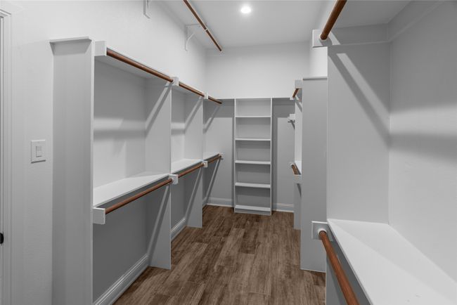 Walk in closet featuring dark wood finished floors | Image 20