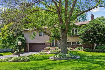 A 2-story addition spans the entire backside of this welcoming home offering terrific private views of the large backyard & pond. Hidden behind the garage door you’ll find 4 tandem parking stalls and a heated workshop! | Image 1