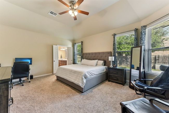 Spacious and serene, the primary bedroom is tucked away for privacy and offers the perfect retreat at the end of the day | Image 15