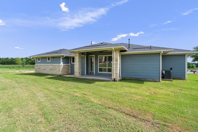 Rear view of house, covered patio, back yard and greenbelt to the side with a walking trail | Image 23