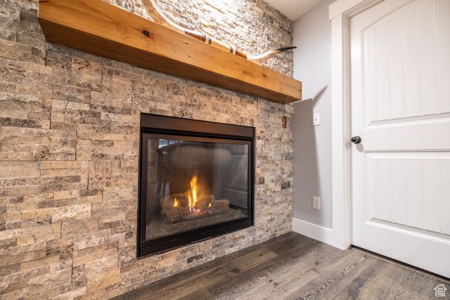 Detailed view of wood finished floors and a glass covered fireplace | Image 25