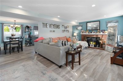 Enter into the spacious living room. Bright, neutral colors and recessed lighting. | Image 2