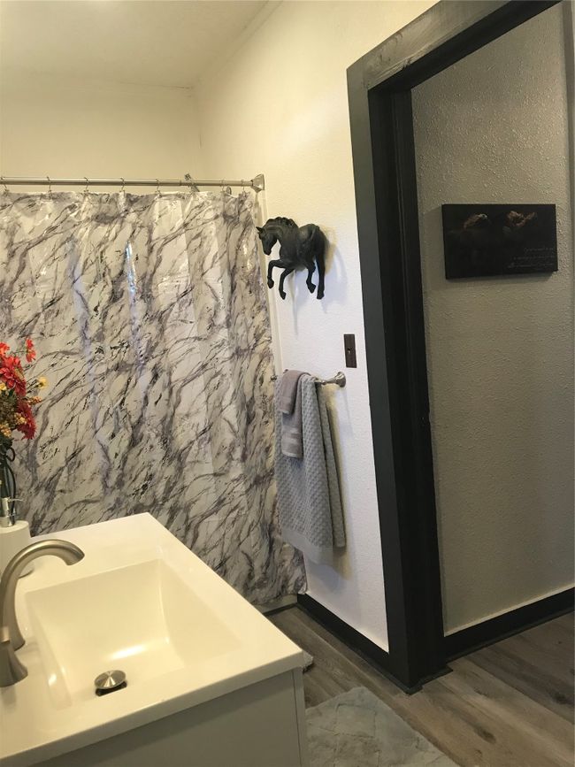 Bathroom featuring a sink, baseboards, and wood finished floors | Image 22