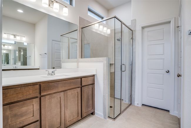 Bathroom featuring a shower stall, vanity, and tile patterned floors | Image 15