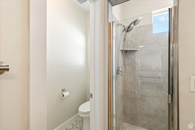 Full bath featuring toilet and a stall shower | Image 27