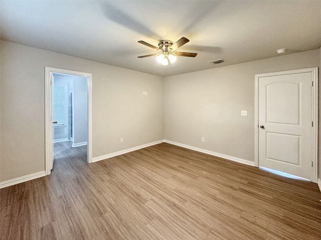 Unfurnished room with a ceiling fan and wood finished floors | Image 6