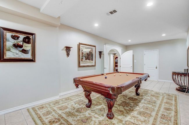 Rec room with arched walkways, recessed lighting, light tile patterned floors, and pool table | Image 27