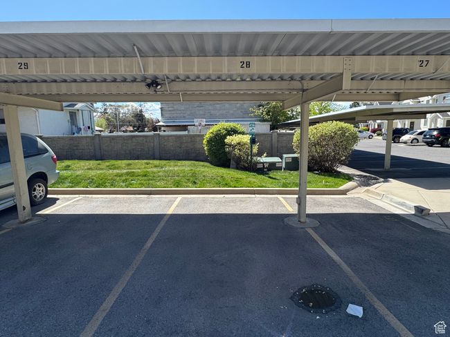Covered parking lot featuring fence | Image 12