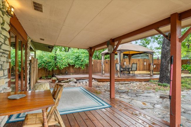 Wooden deck with outdoor dining space, a fenced backyard, and a gazebo | Image 25