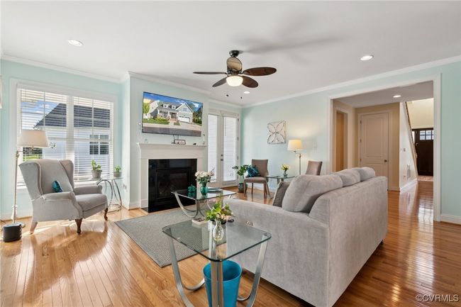 Direct vent gas fireplace with mantle and HD MEDIA package for easy wire management. Front entry can be seen to the right, and glass doors in center of picture lead to the side courtyard patio. | Image 13