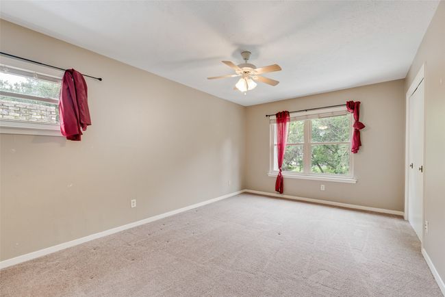 Unfurnished room with a ceiling fan, baseboards, and carpet floors | Image 15