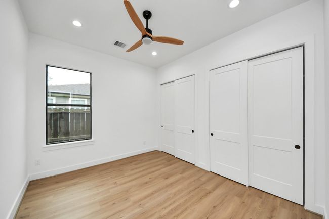 Secondary bedroom features awindow, ceiling fan, and recessed lighting. | Image 21