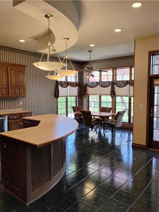 Kitchen with custom oak baseboards, a kitchen island, and recessed lighting | Image 35