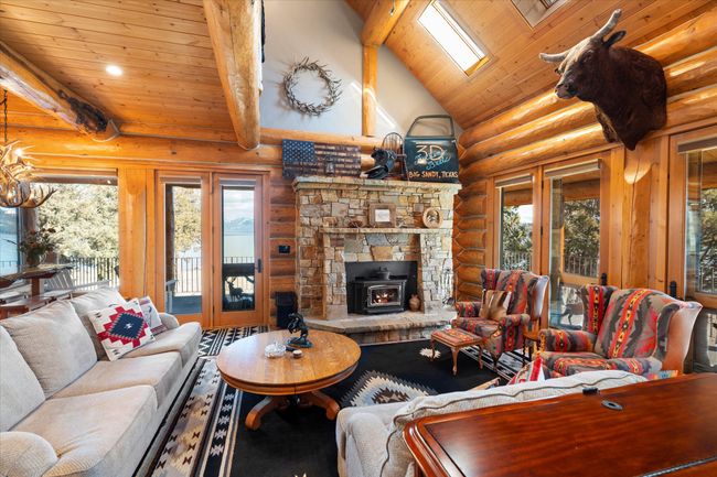 Main level living area. Custom stone fireplace. | Image 39