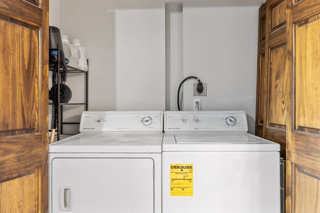 Clothes washing area featuring washer and clothes dryer and laundry area | Image 21