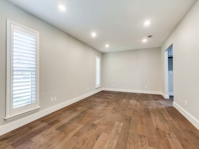 Unfurnished room with dark wood finished floors, baseboards, and recessed lighting | Image 12