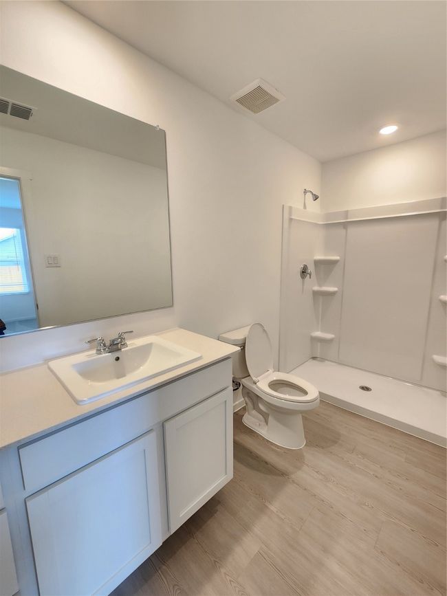 Full bath with a shower, vanity, and wood finished floors | Image 9
