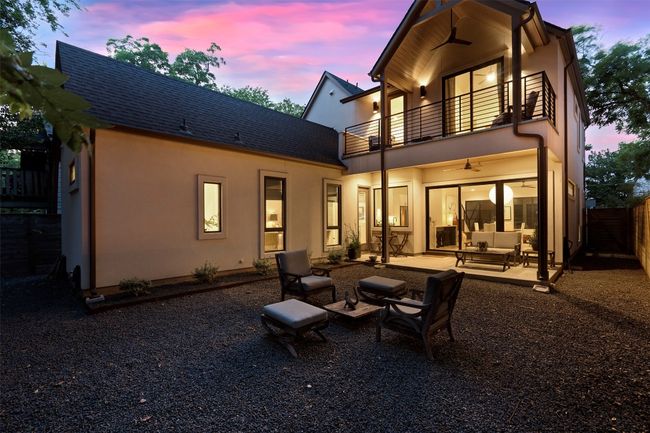 Rear view of house featuring a balcony, a ceiling fan, a patio area, and stucco siding | Image 5