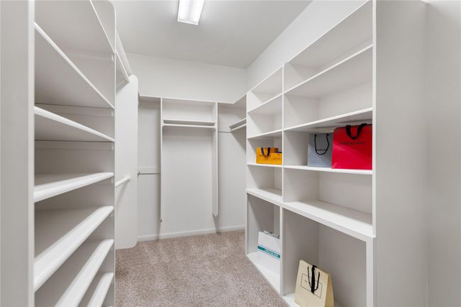 One of TWO primary bedroom walk-in closets | Image 17