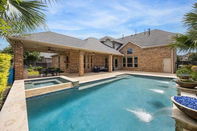 Heated Pool and Spa with Automated Lights, gas fire bowls, gorgeous water features surrounded by travertine and cool decking for the best summer days spent outside! | Image 39
