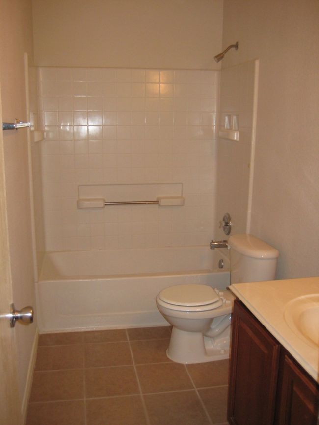 Full bathroom with vanity, tile patterned floors, and bathing tub / shower combination | Image 11